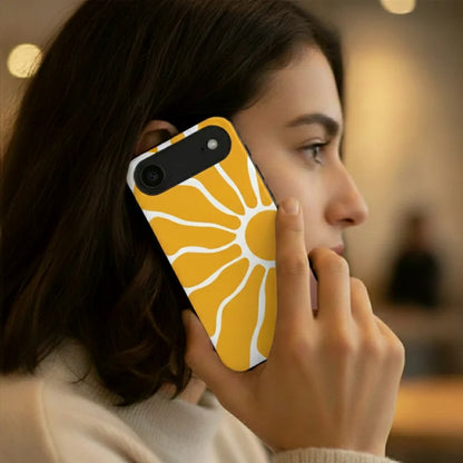 A phone case featuring a retro-style yellow sunburst pattern with white rays, shown on a black smartphone against a plain white background.
